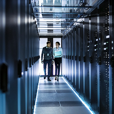 Technicians walking through data center