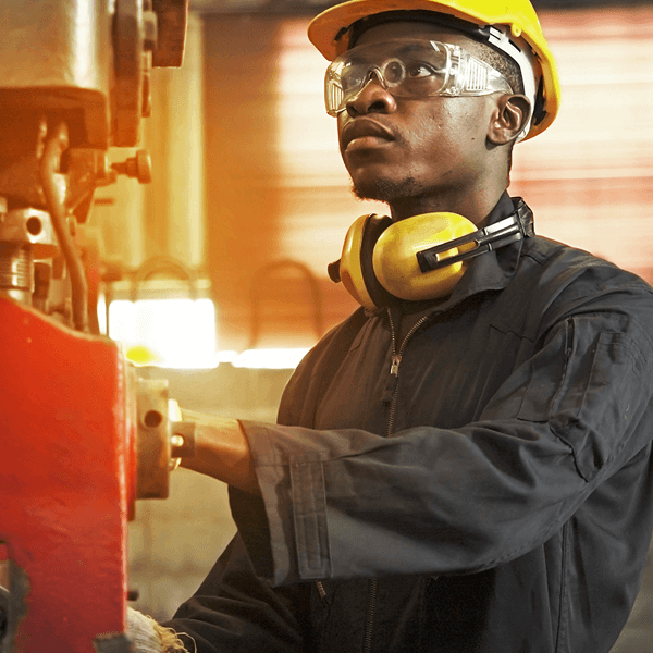 Worker in factory with safety gear